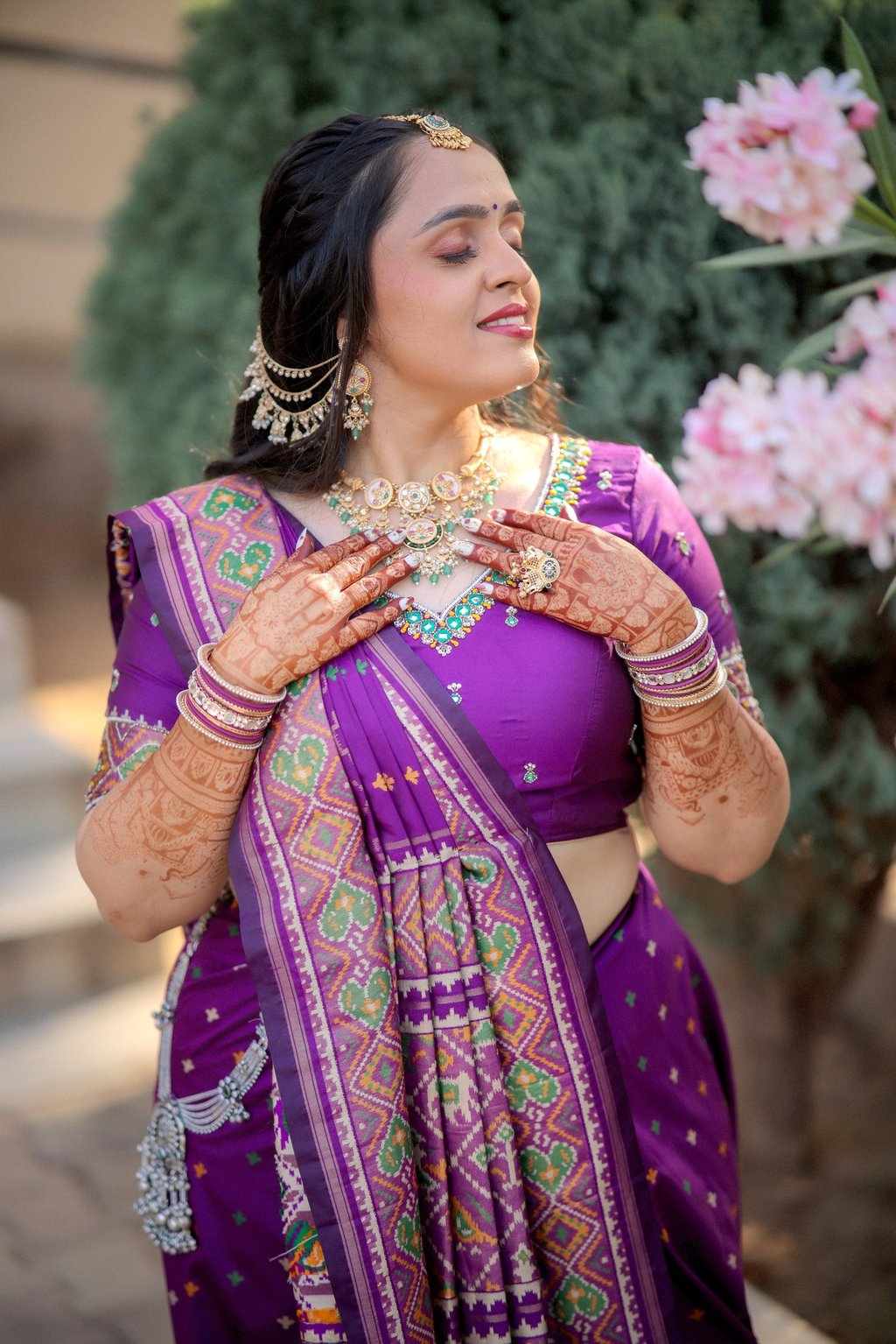 "Indian bride in royal purple Patola silk saree with full-arm bridal mehendi and kundan jewellery — 