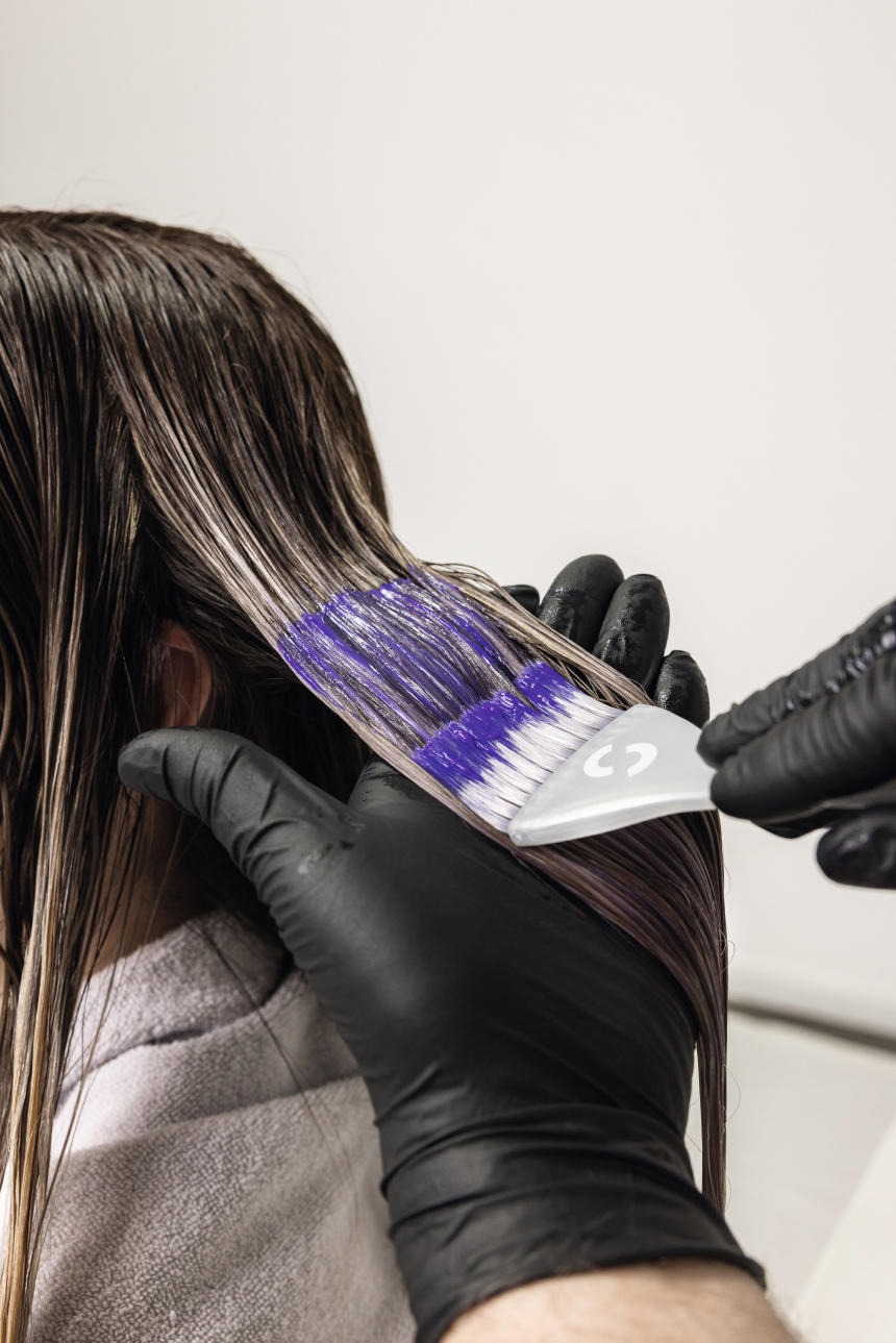 a woman is shown in a salon while her hair is dyed out