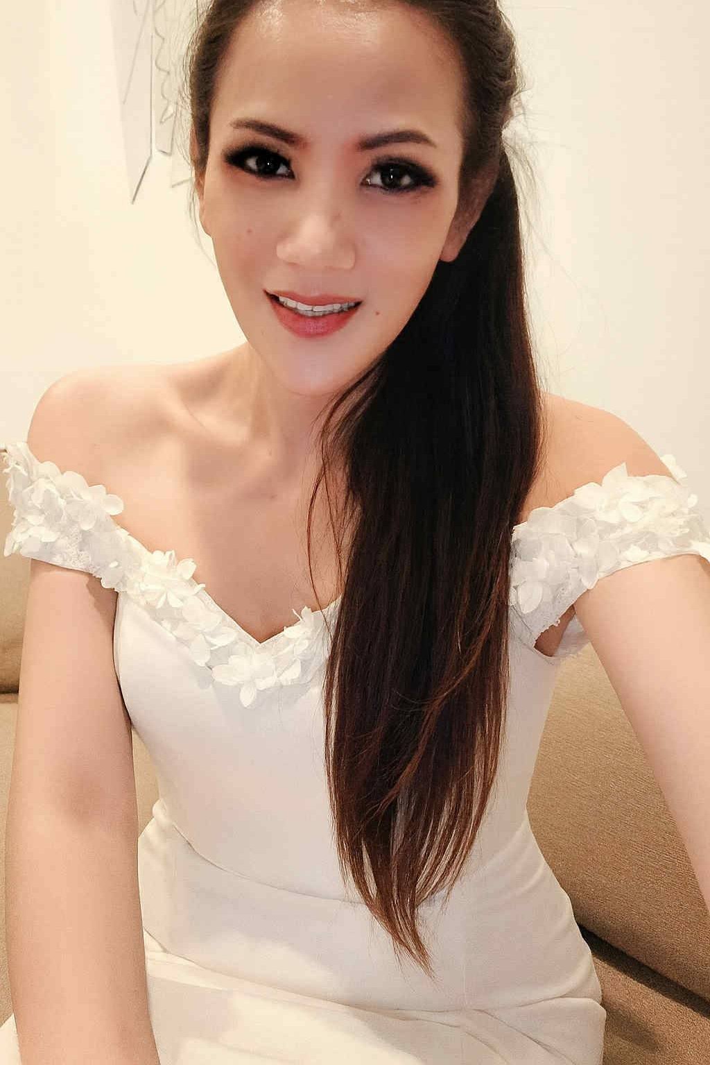 Ladyboy therapist wearing a frilly of the shoulder white dress
