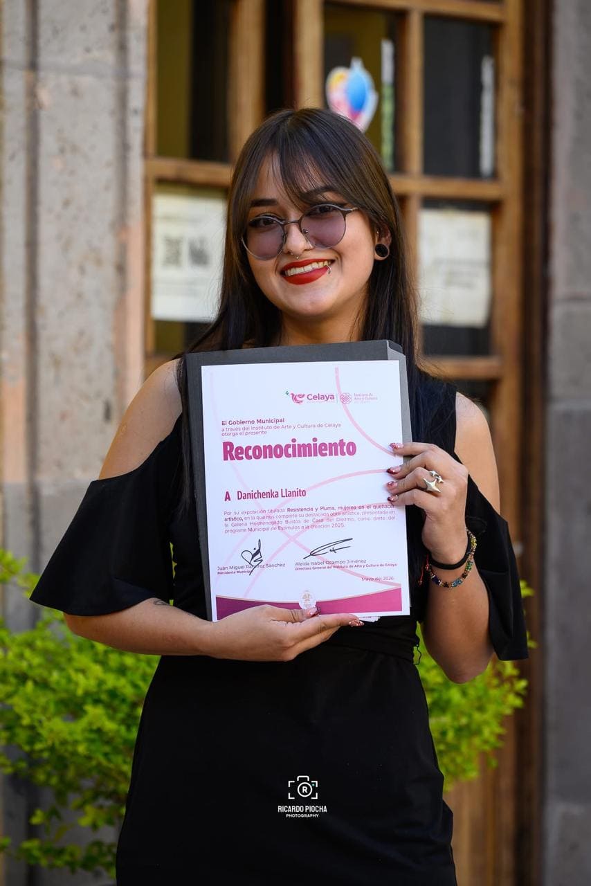Danichenka Llanito recibiendo un reconocimiento por una exposición 