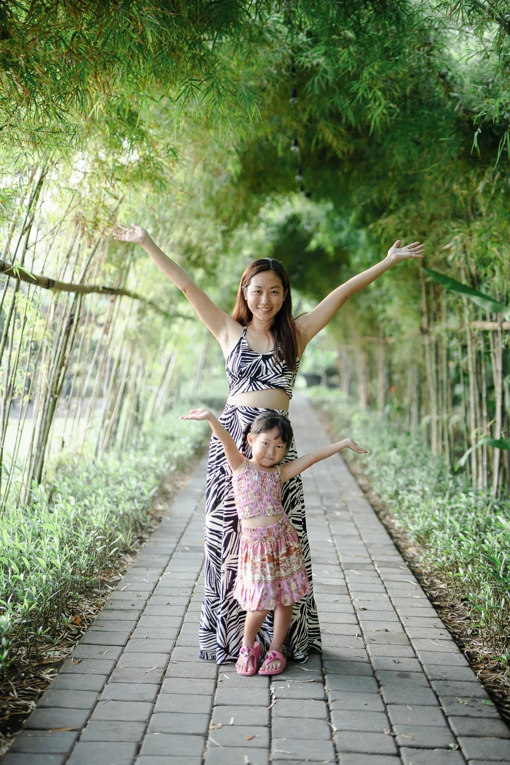 Lifestyle portrait of woman at Padma Resort Legian Bali surrounded by tropical greenery and soft natural light.