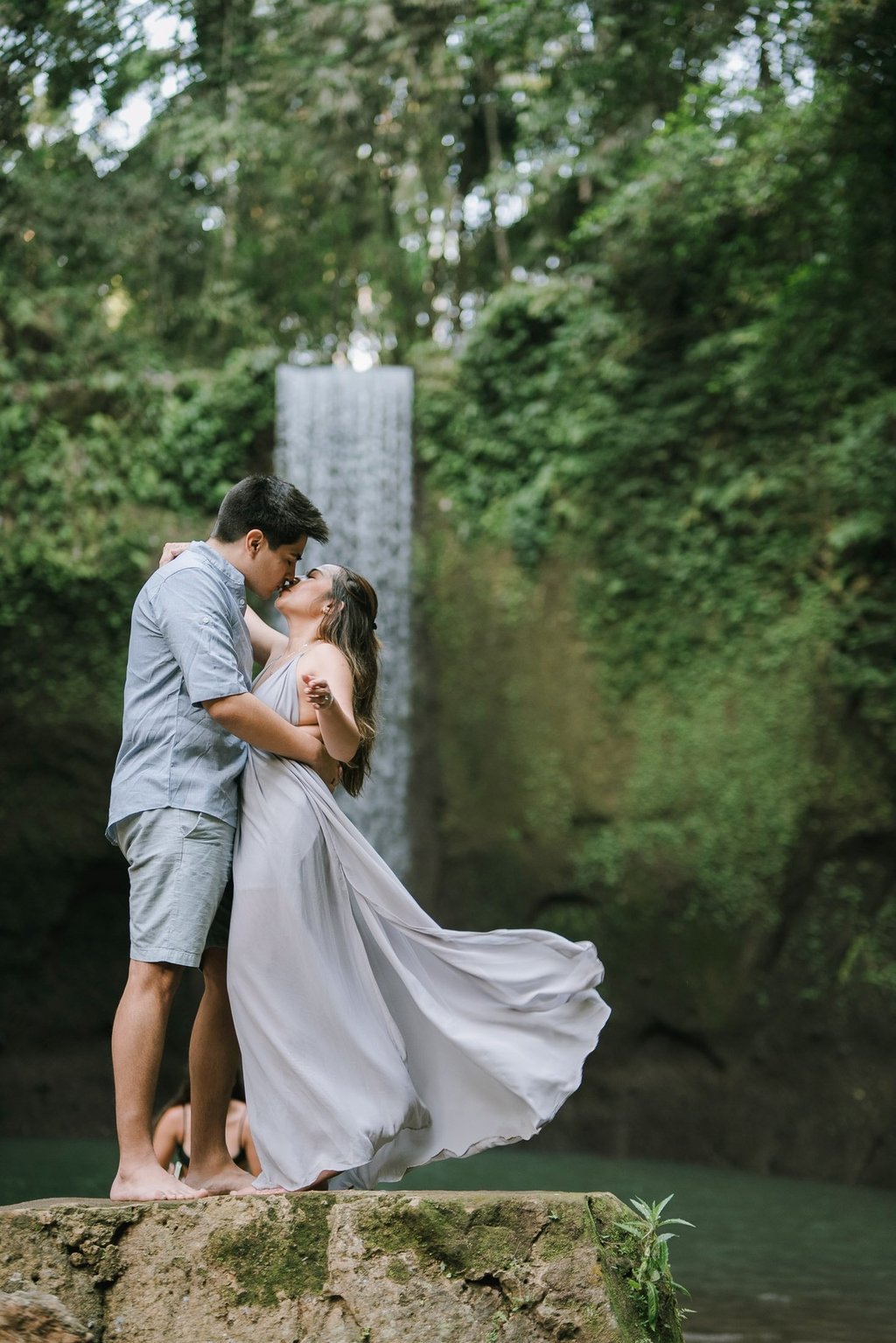 Romantic prewedding couple with flowing dress at Tibumana Waterfall Bangli Bali