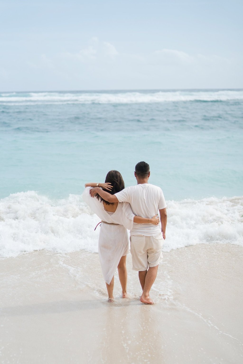 Couple from behind looking at the ocean at Karma Kandara Bali beach  