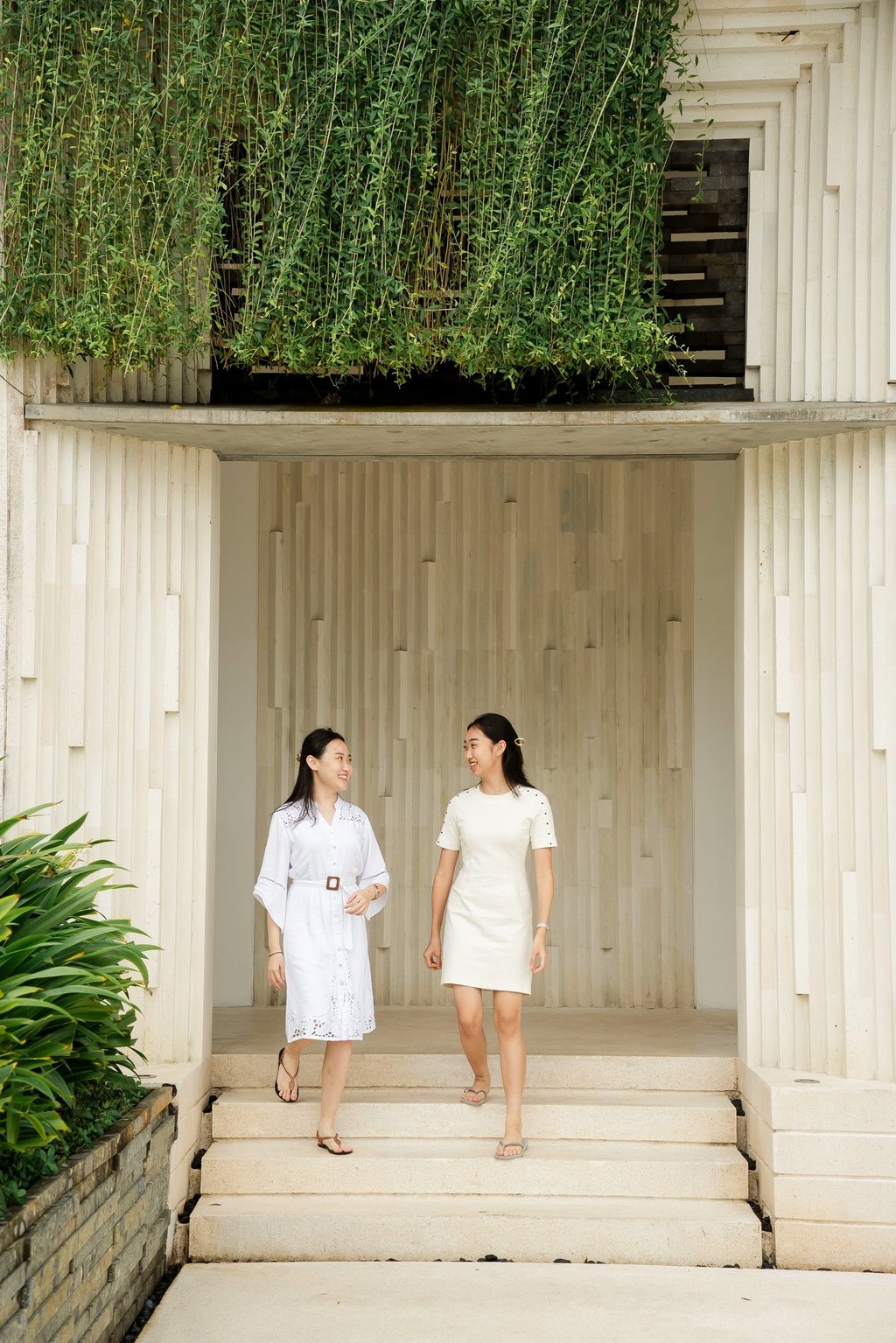 family walking through the minimalist architecture of Alila Villas Uluwatu during a private session in Bali
