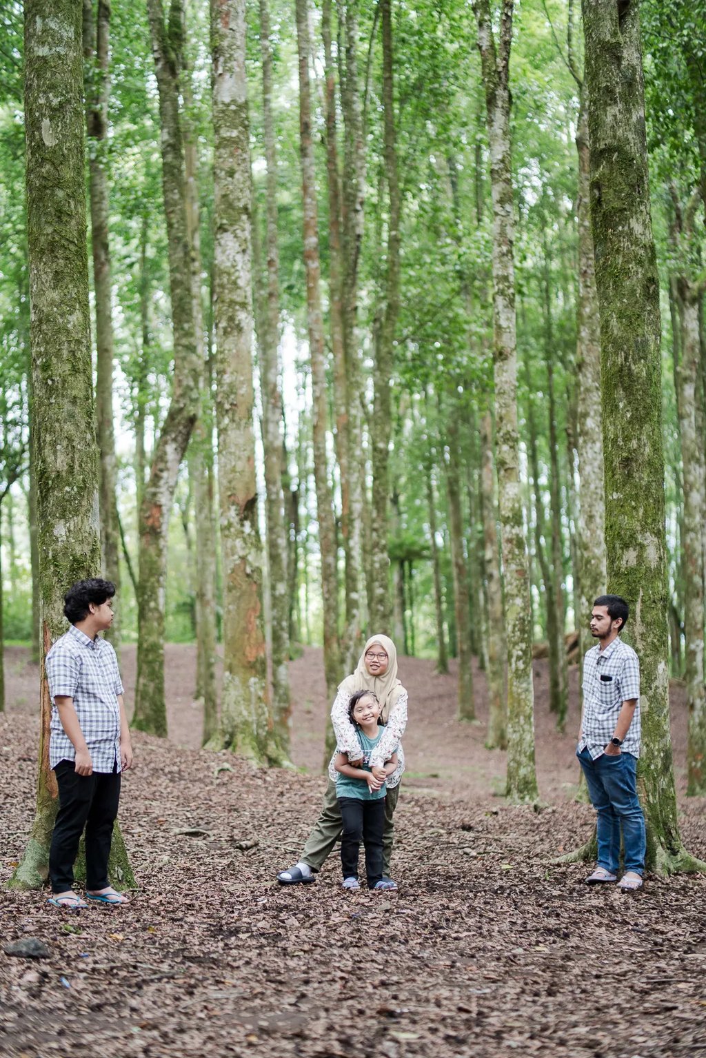 Iqbal family walking through Botanical Garden during a family photography session in Bedugul Bali.