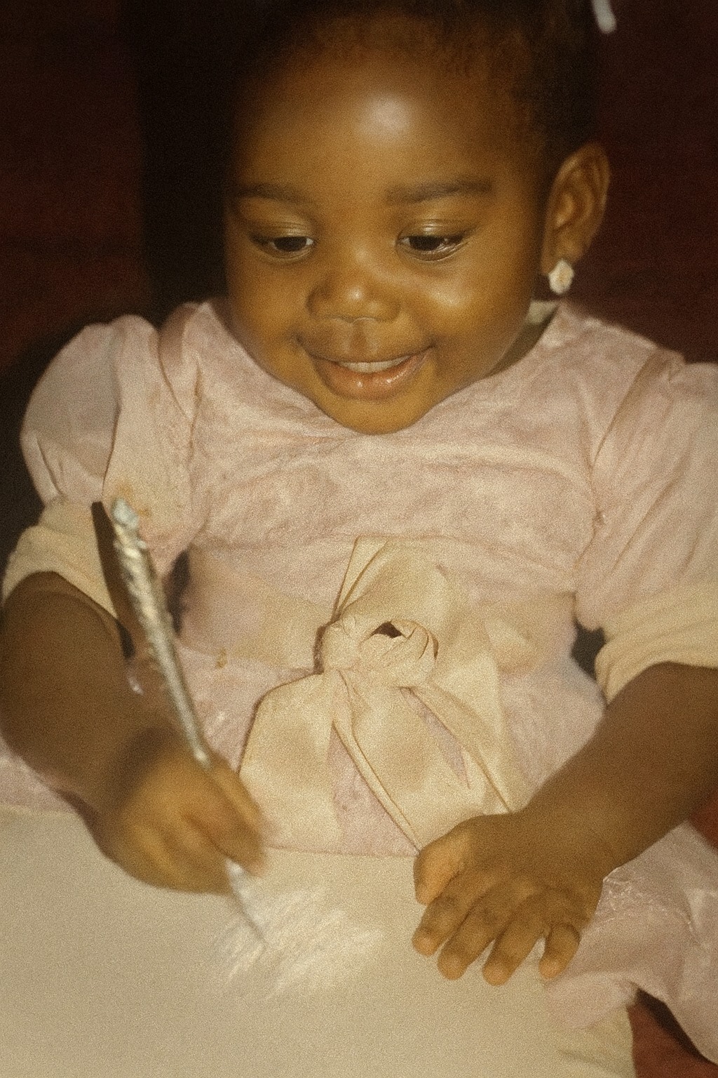 Iheoma Uzomba childhood photo with pen