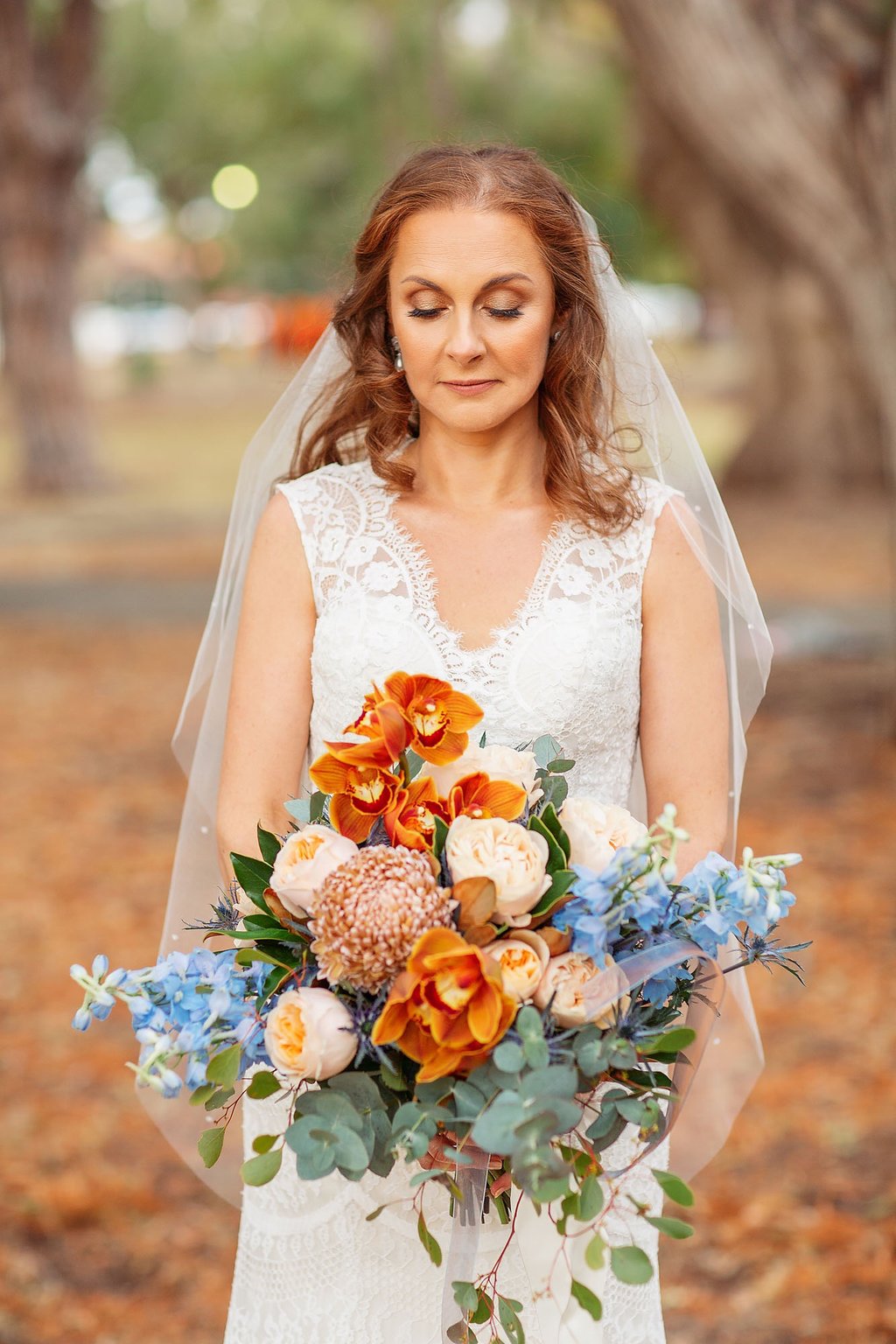 a bride in a white wedding dress holding a bouquet