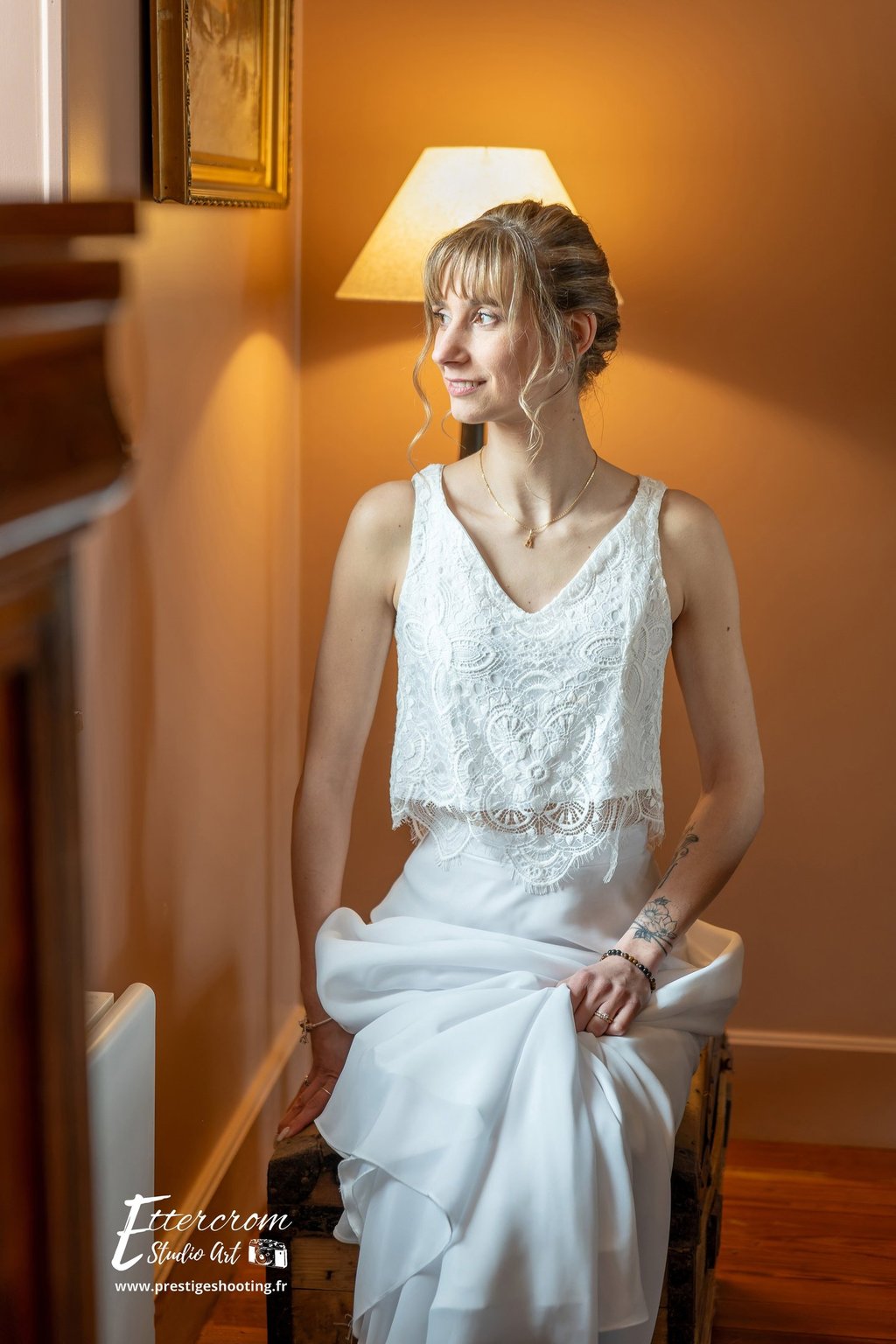 a woman in a white dress sitting on a chair