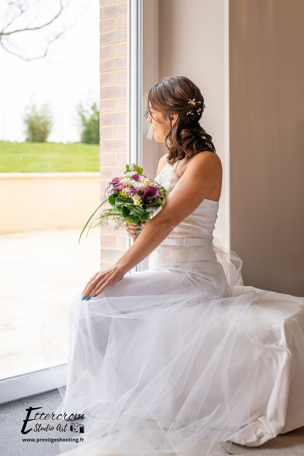a bridesmaid sitting on a bench in a window