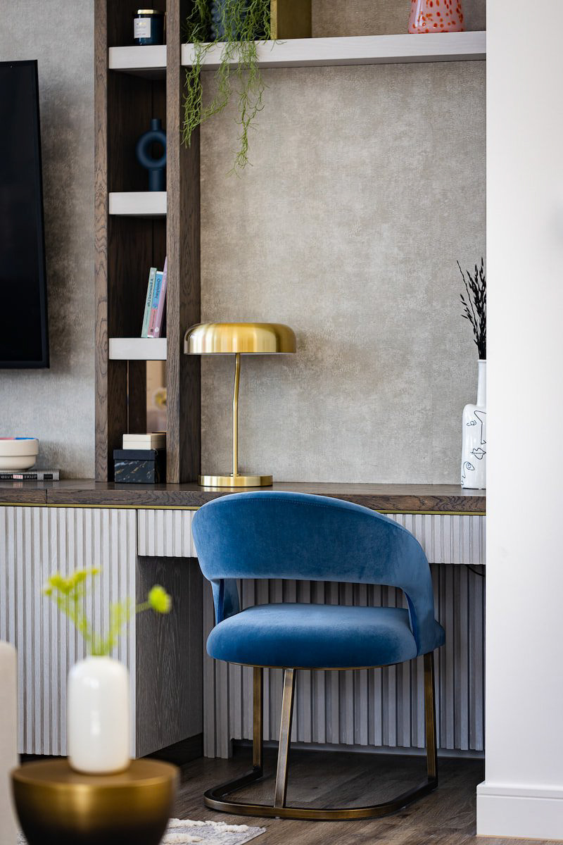 a blue chair with a blue chair and a tv