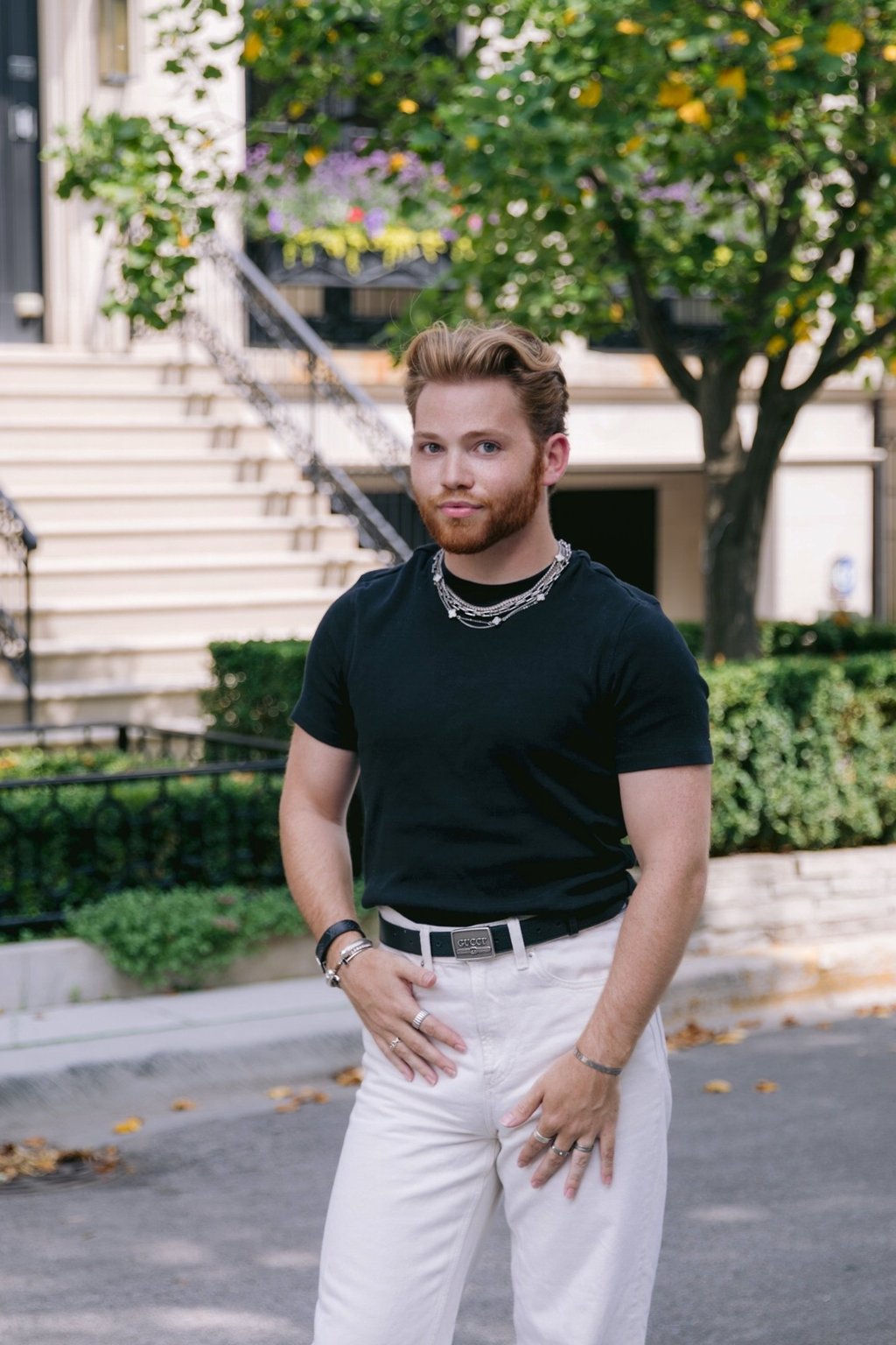 a man in a black shirt and white pants