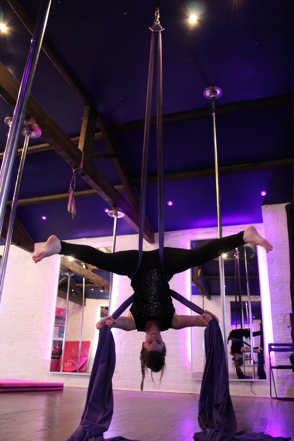 Image of student at Sxefit aerial silks class upside down