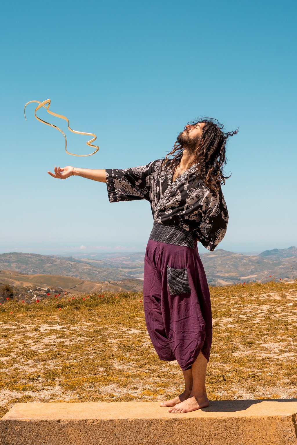 a man in a black dress and a kite kite