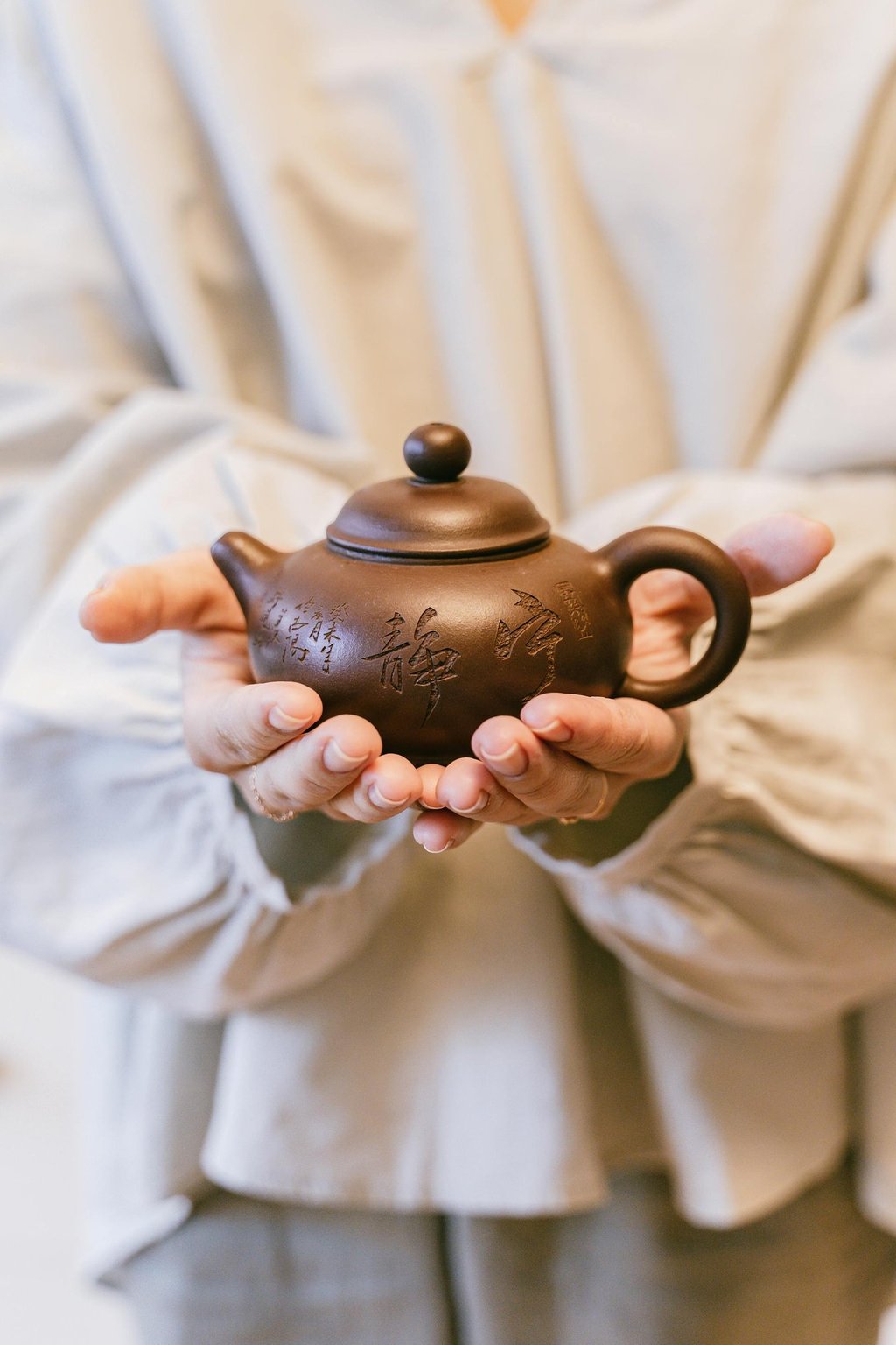 Holding a teapot in hands