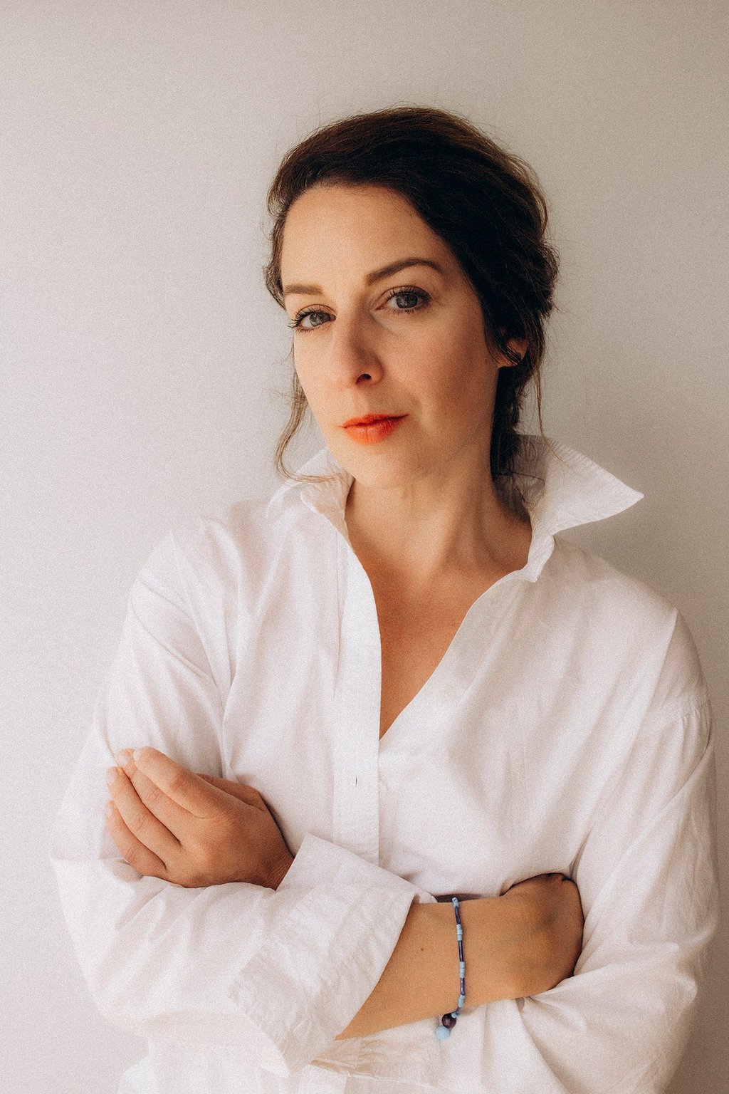 a woman in a white shirt and red lipstick