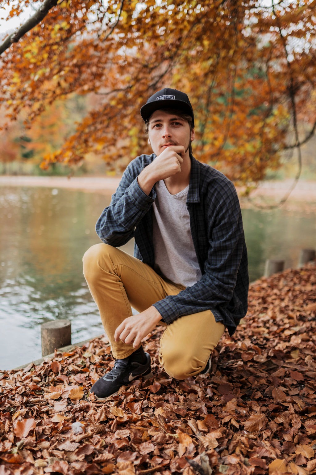 Marc Brunnert sitting on a pile of leaves
