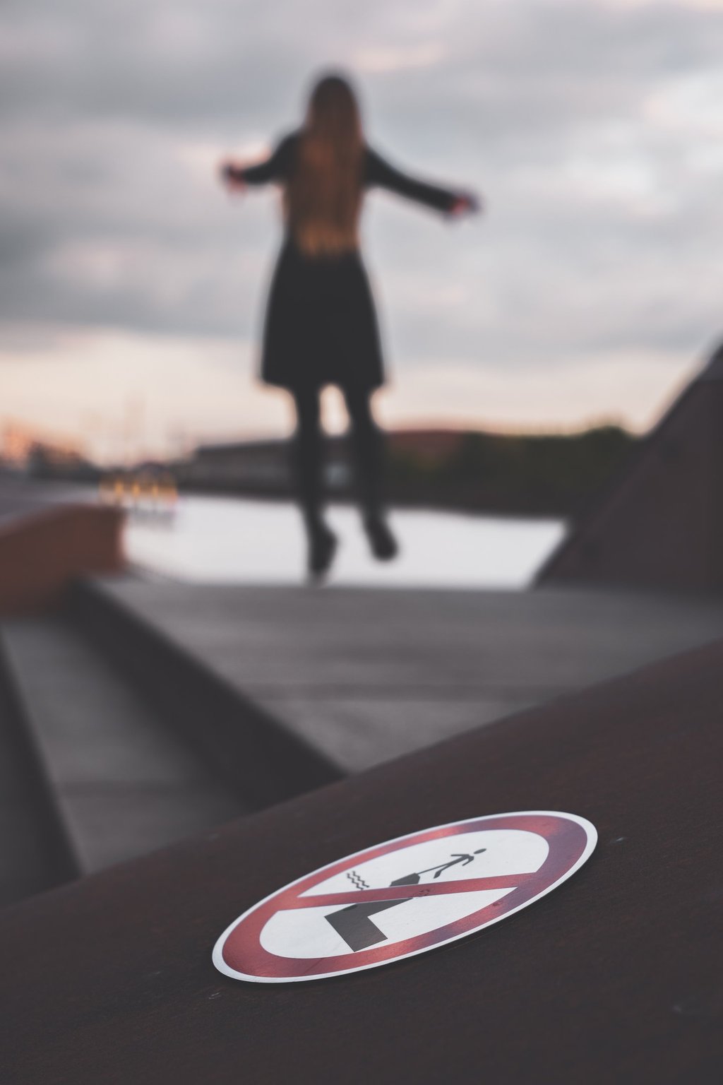 a jumping in the air while a no jumping sign is displayed