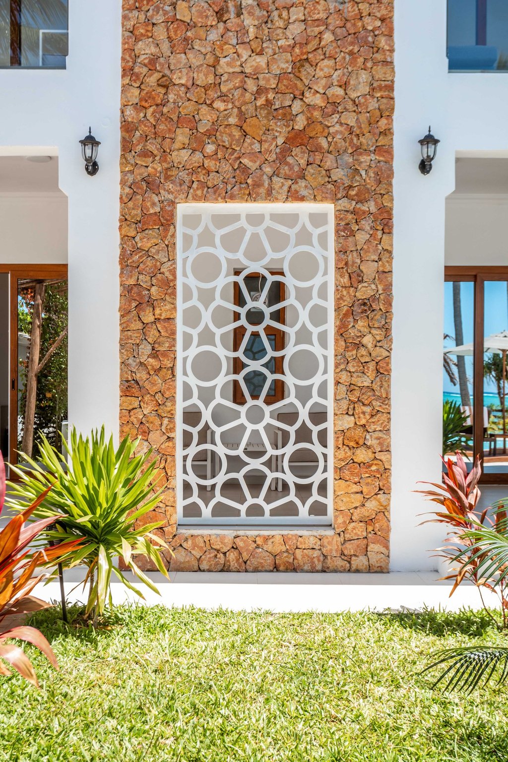 a house with a stone wall and a stone wall