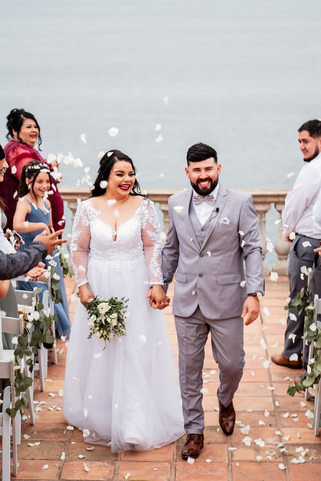 a bride and groom walking down the aisle of a wedding ceremony