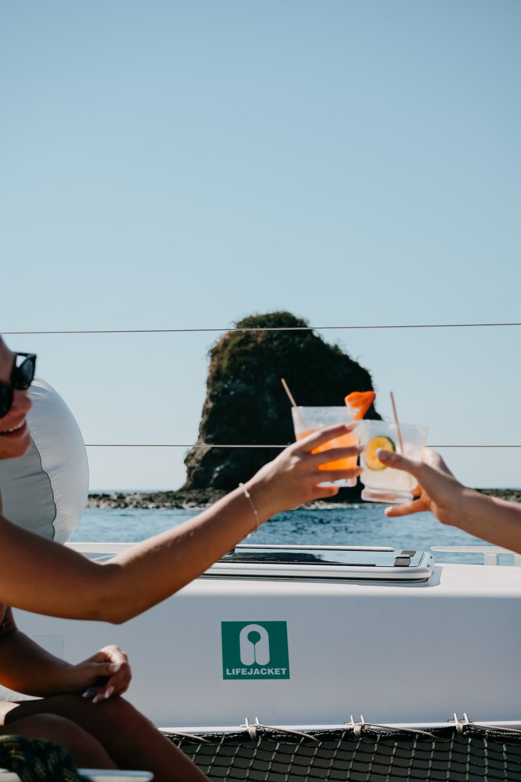 Guests enjoying premium cocktails toast onboard private catamaran in Papagayo Gulf