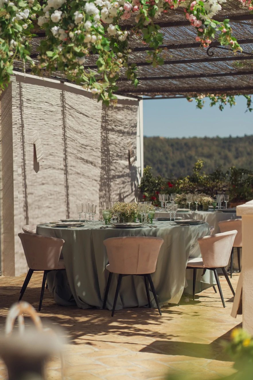 Outdoor dining table under vines at Finca Santa Katerina