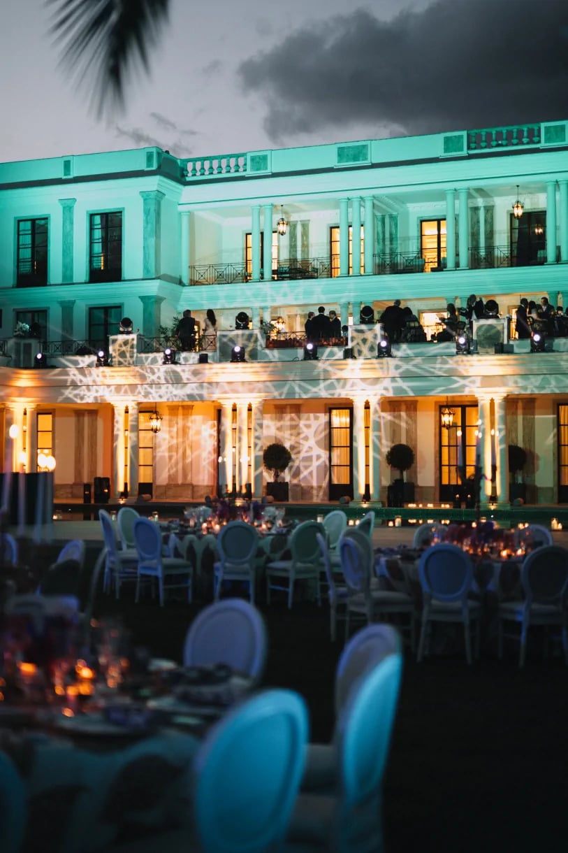 Evening reception in front of illuminated villa façade