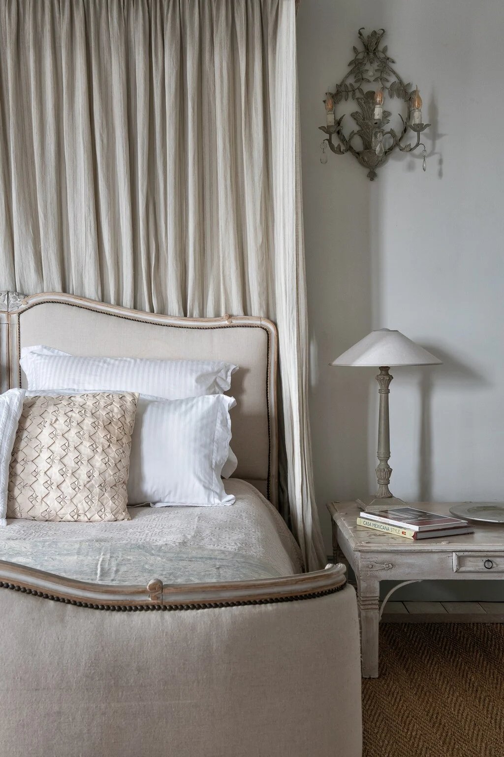 Classic bedroom with neutral tones and tall curtains
