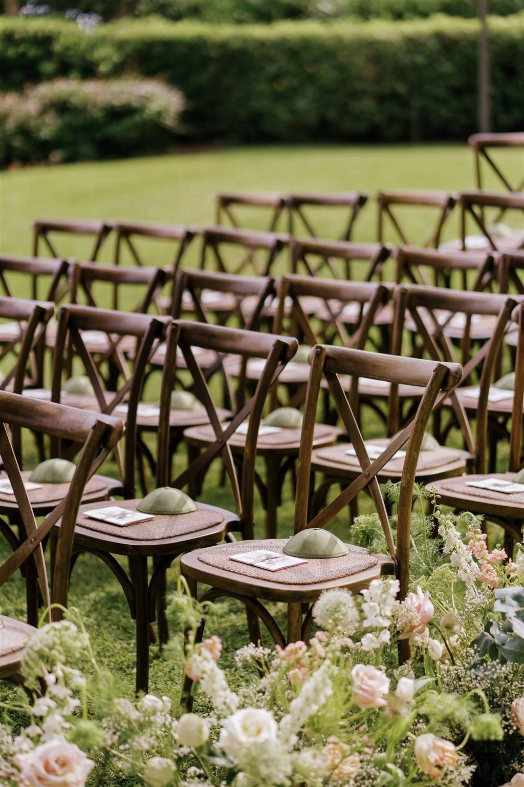 Wooden ceremony chairs with floral aisle details