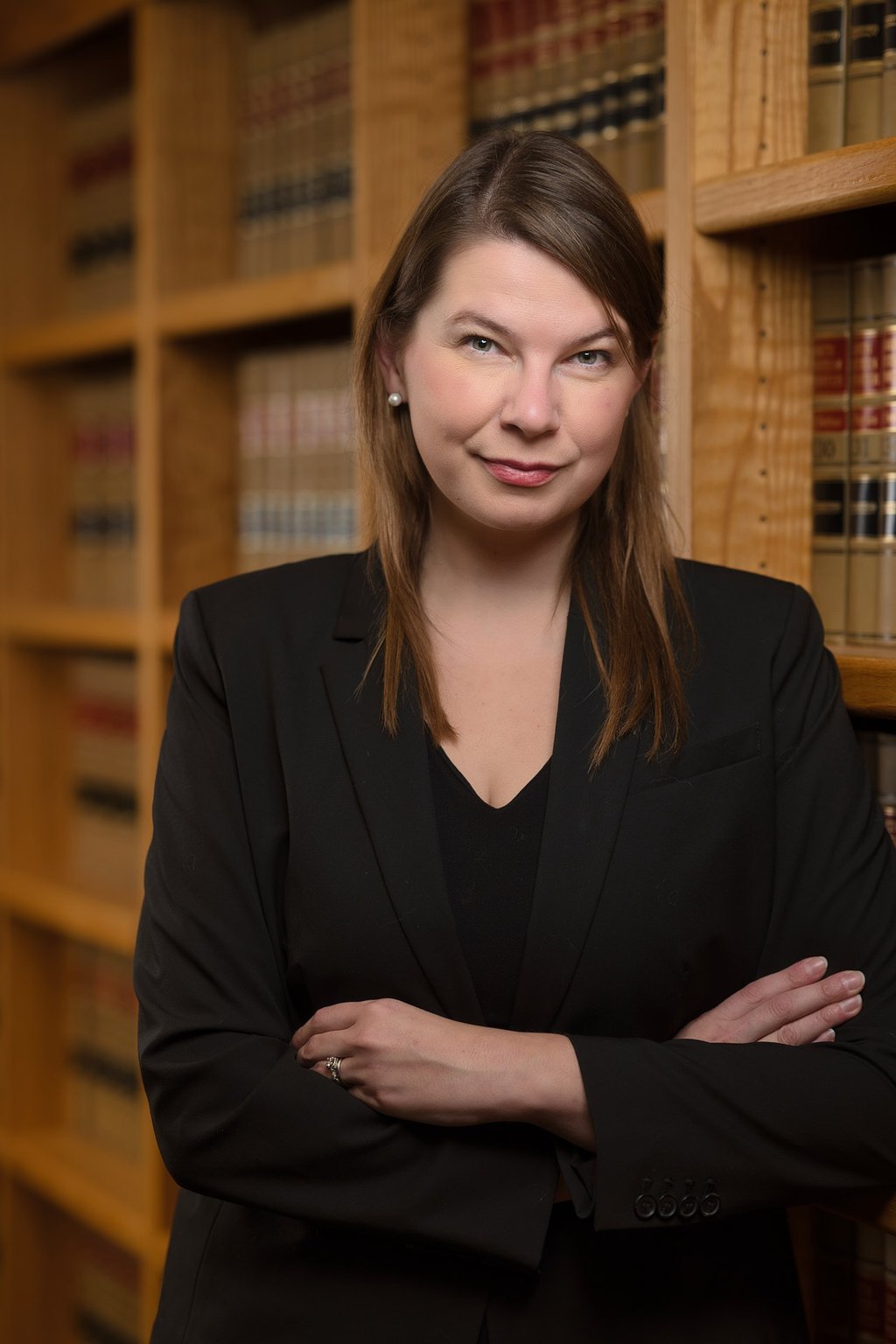 a woman in a suit and a suit jacket in a library
