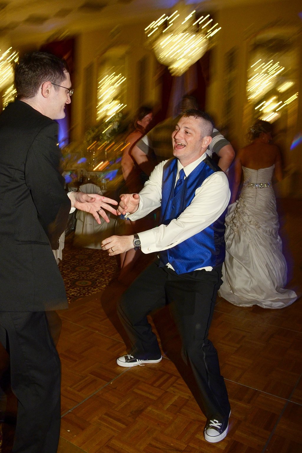 two man dancing at a wedding party in a hotel
