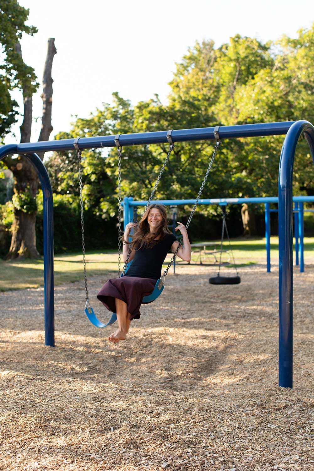 Tina Lilly, MS, LPC at play on a swing set