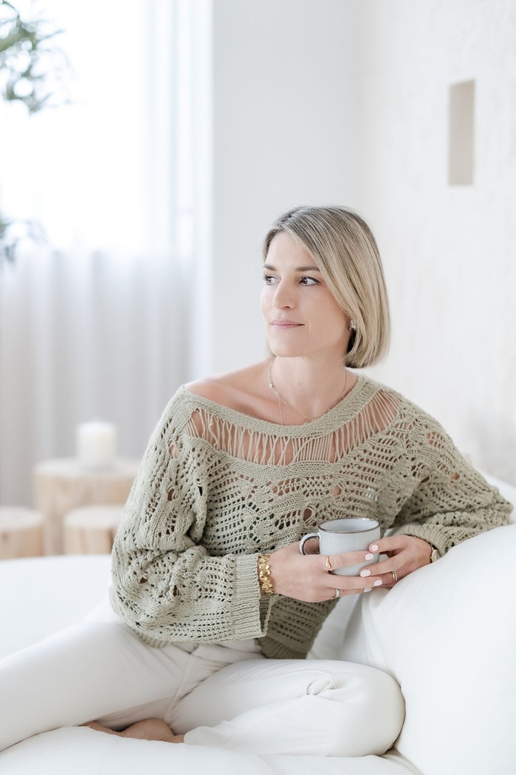 Yvonne, psychotherapist, having a coffee and looking calm, friendly and reflective