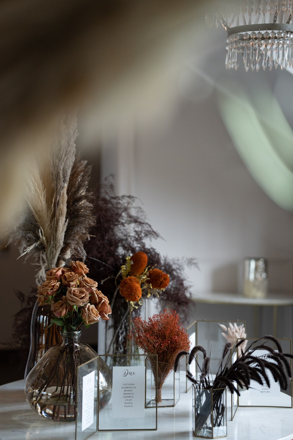 a table with a vase of flowers and a rooster, wedding
