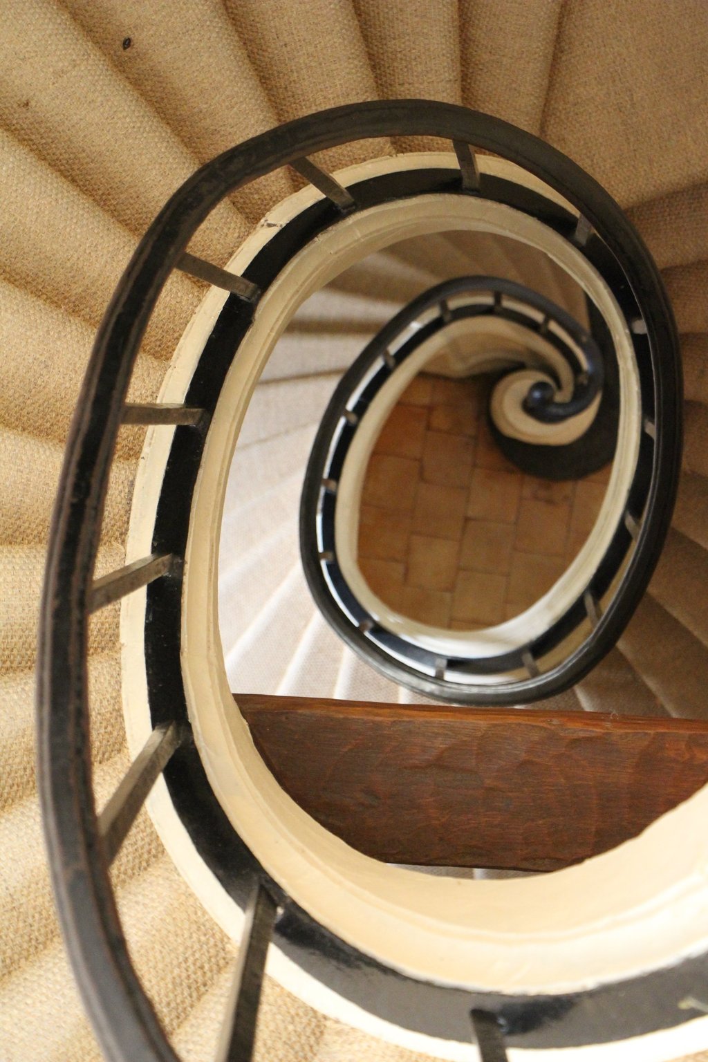 a spiral staircase with a wooden staircase case