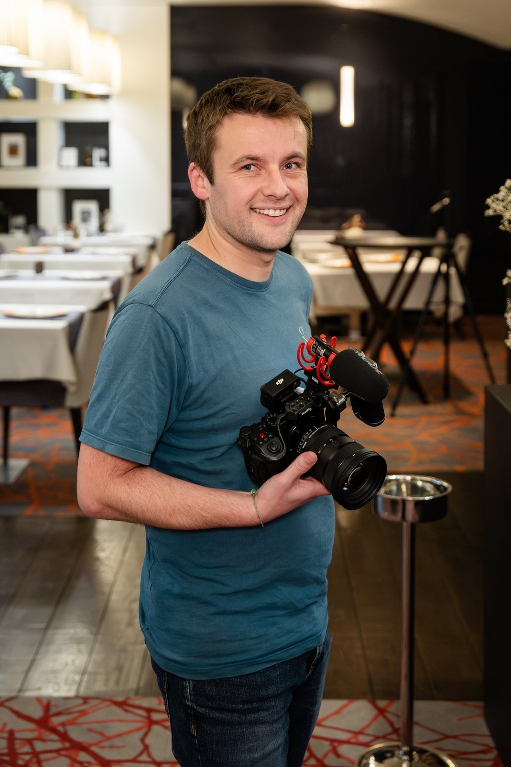 a man holding a camera and smiling
