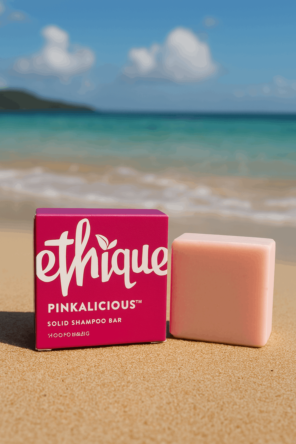 A bar of Ethique Pinkalicious shampoo sitting in the golden sands of a Thai beach 