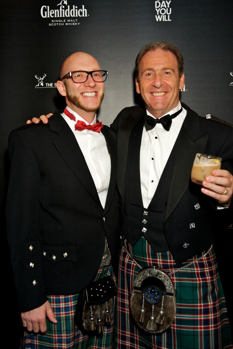 two men in kilts and happy and enjoying an event