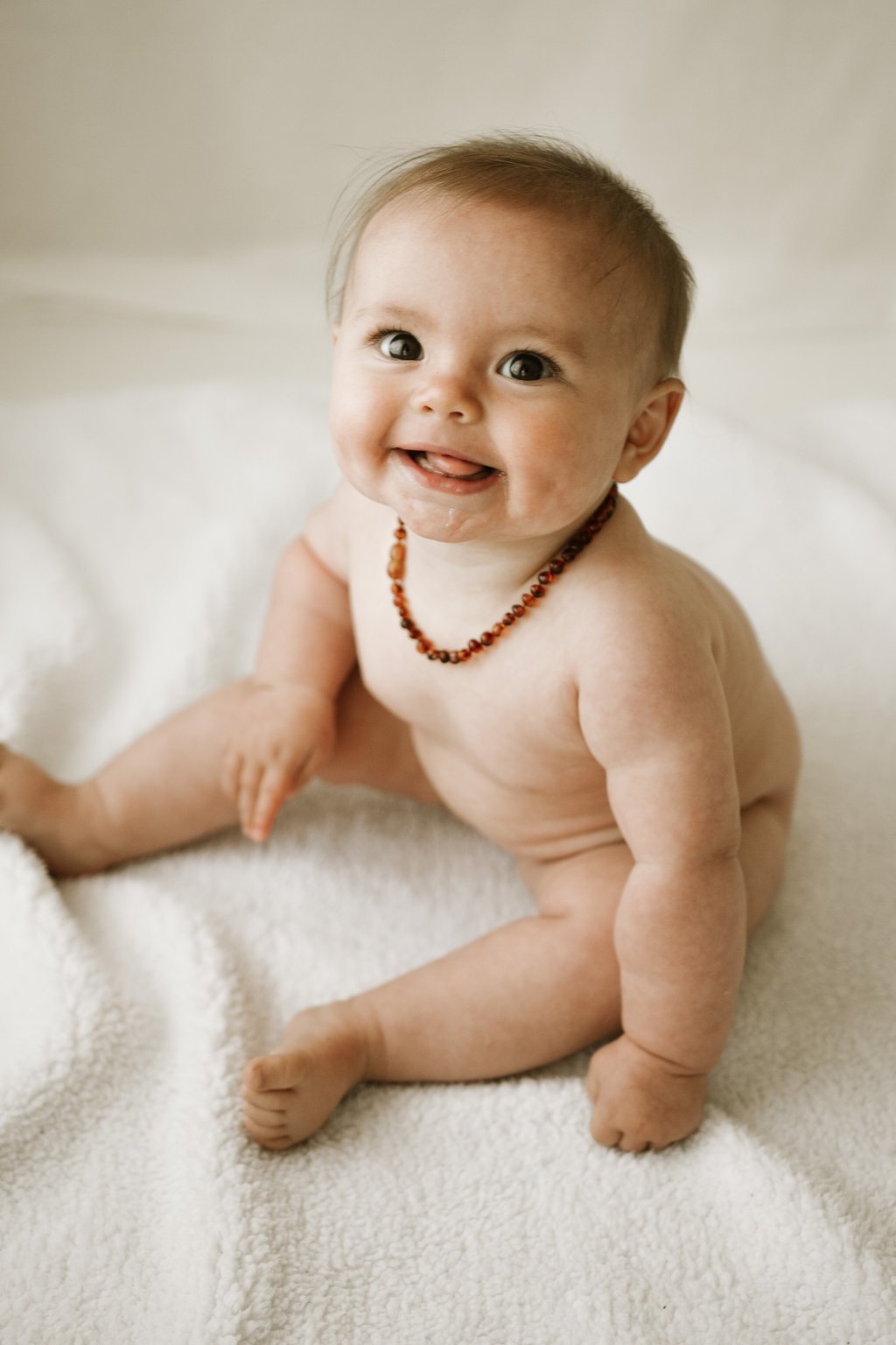 a baby sitting about 6 months old, taken in a natural light studio in Adelaide Hills