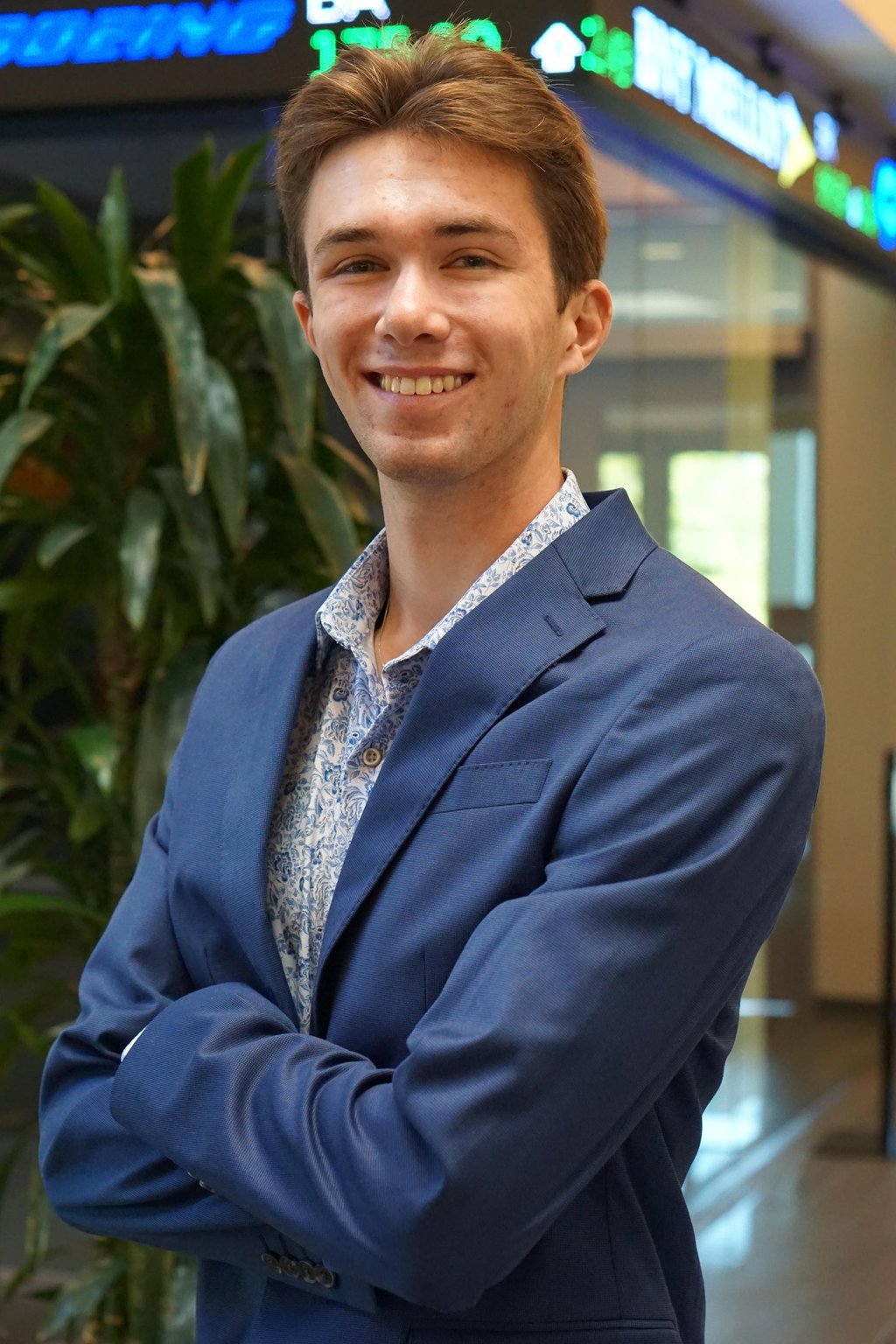 A headshot of Luke Gilmore in a suit.