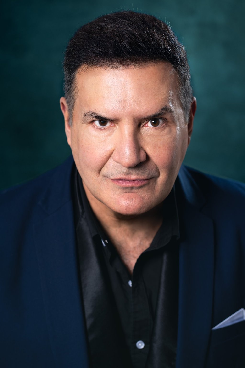 a man in a suit and tie with a black shirt