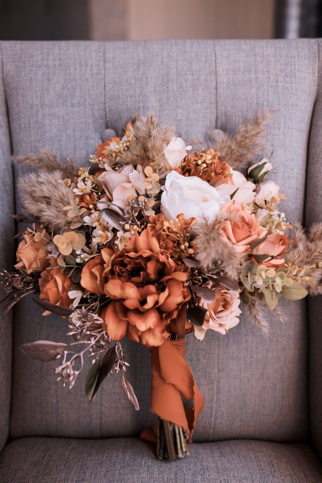 a bouquet of autumn flowers on a chair