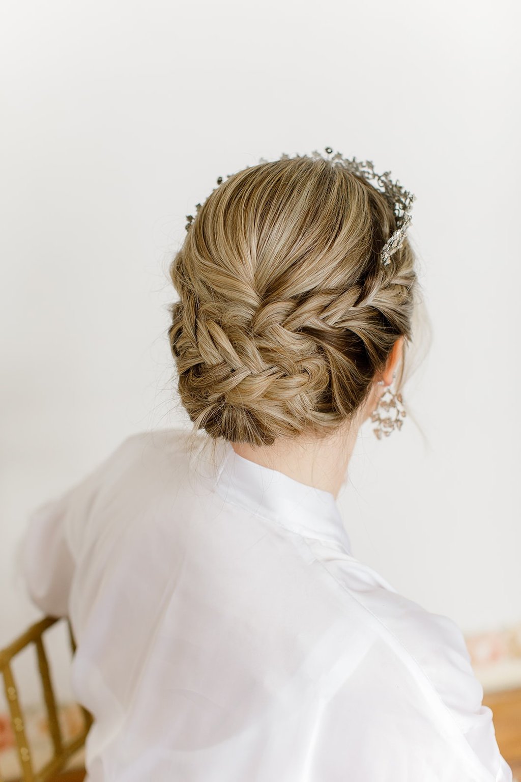 Braided updo for blonde bride on her wedding day Atmosphere Photography