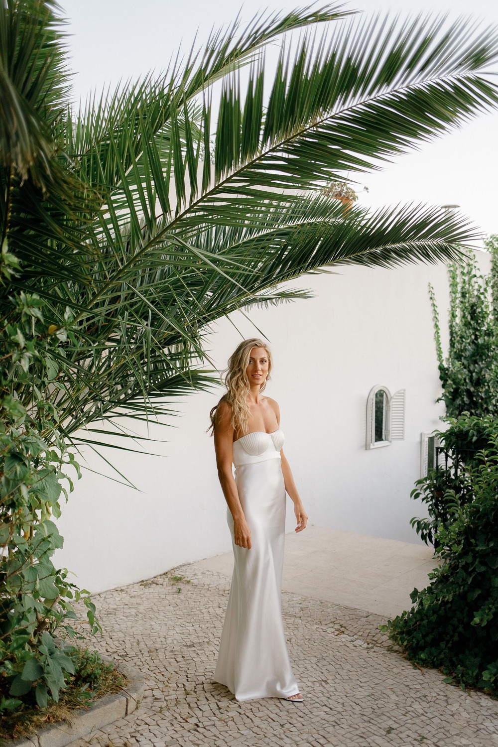 Bride in a white wedding dress with loose long hair and beach waves