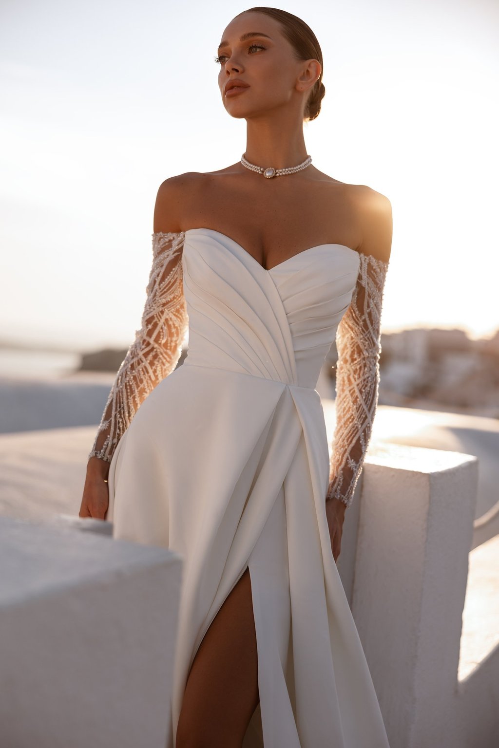 a woman in a white dress with a long sleeved dress