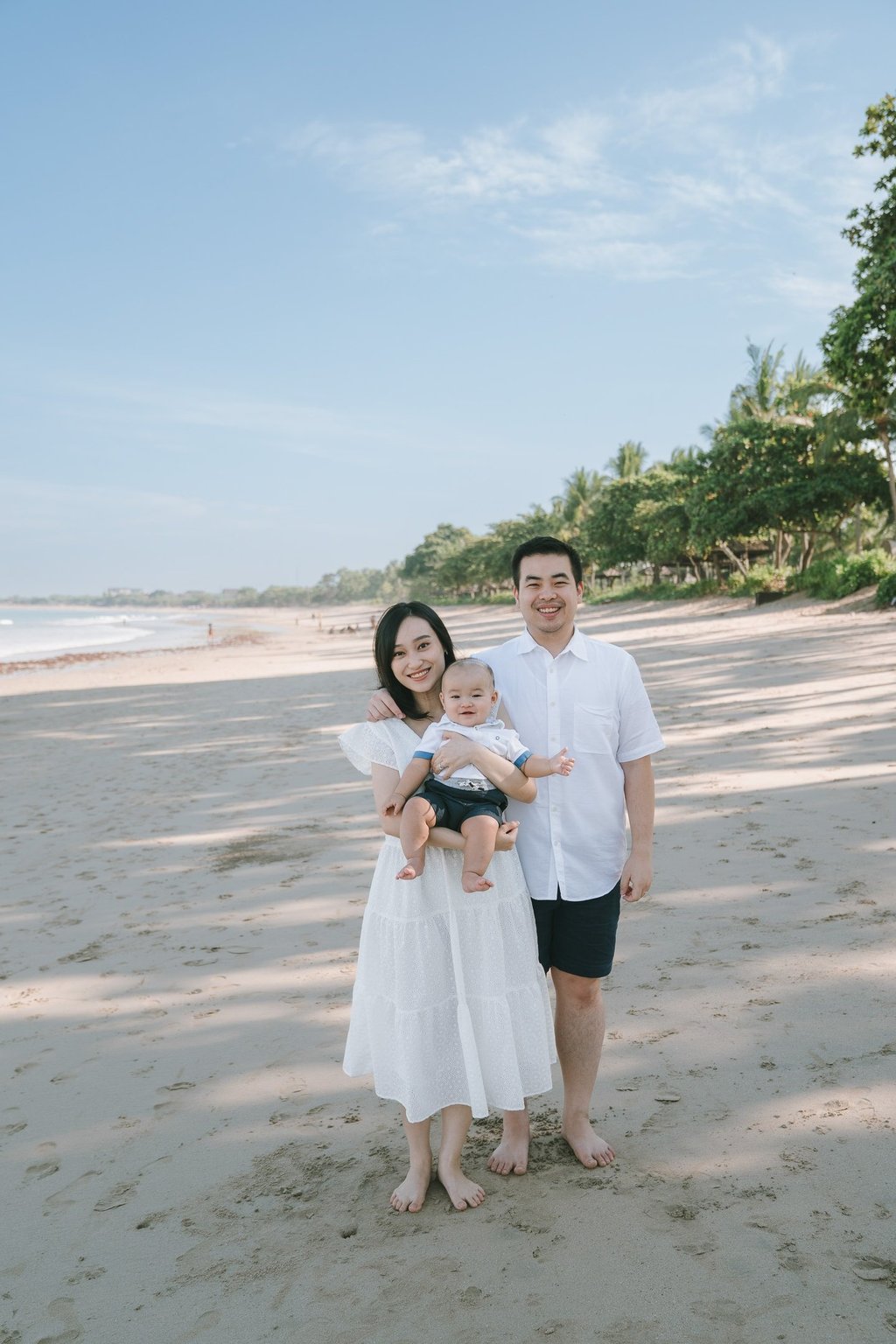 Family walking together on the beach at Intercontinental Jimbaran during a relaxed Bali family photography session
