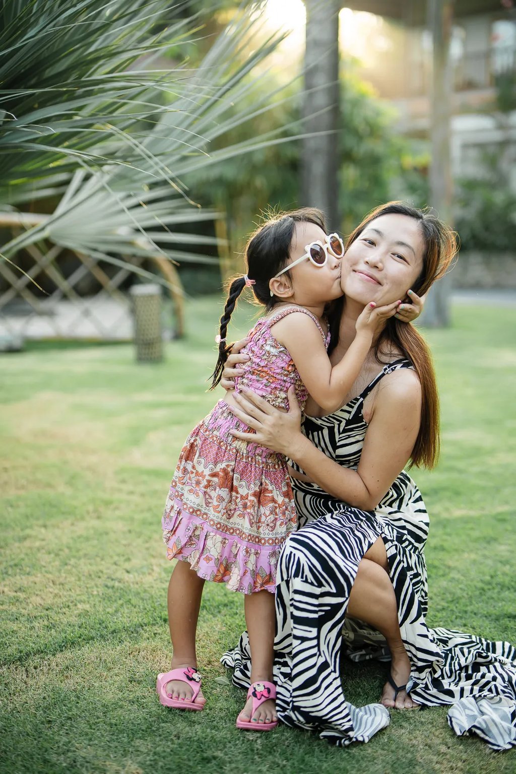 Mother and daughter portrait at Padma Resort Legian Bali with soft tropical sunset light.