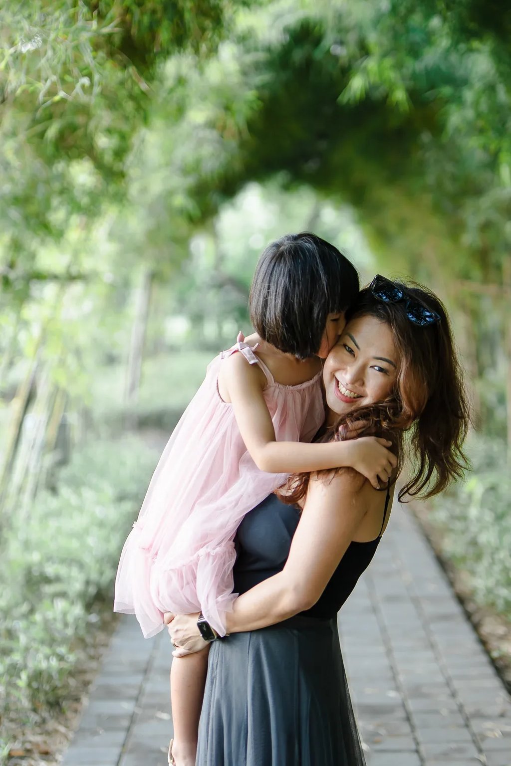 Mother and daughter sharing affectionate moment at Padma Resort Legian Bali during relaxed family photography session.