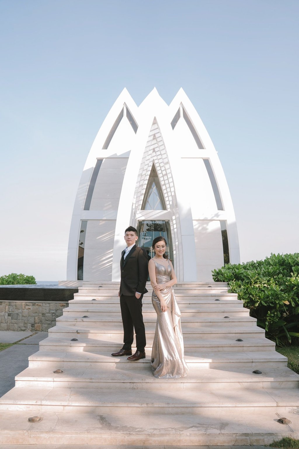 Prewedding couple on chapel stairway at The Ritz-Carlton Nusa Dua Bali.