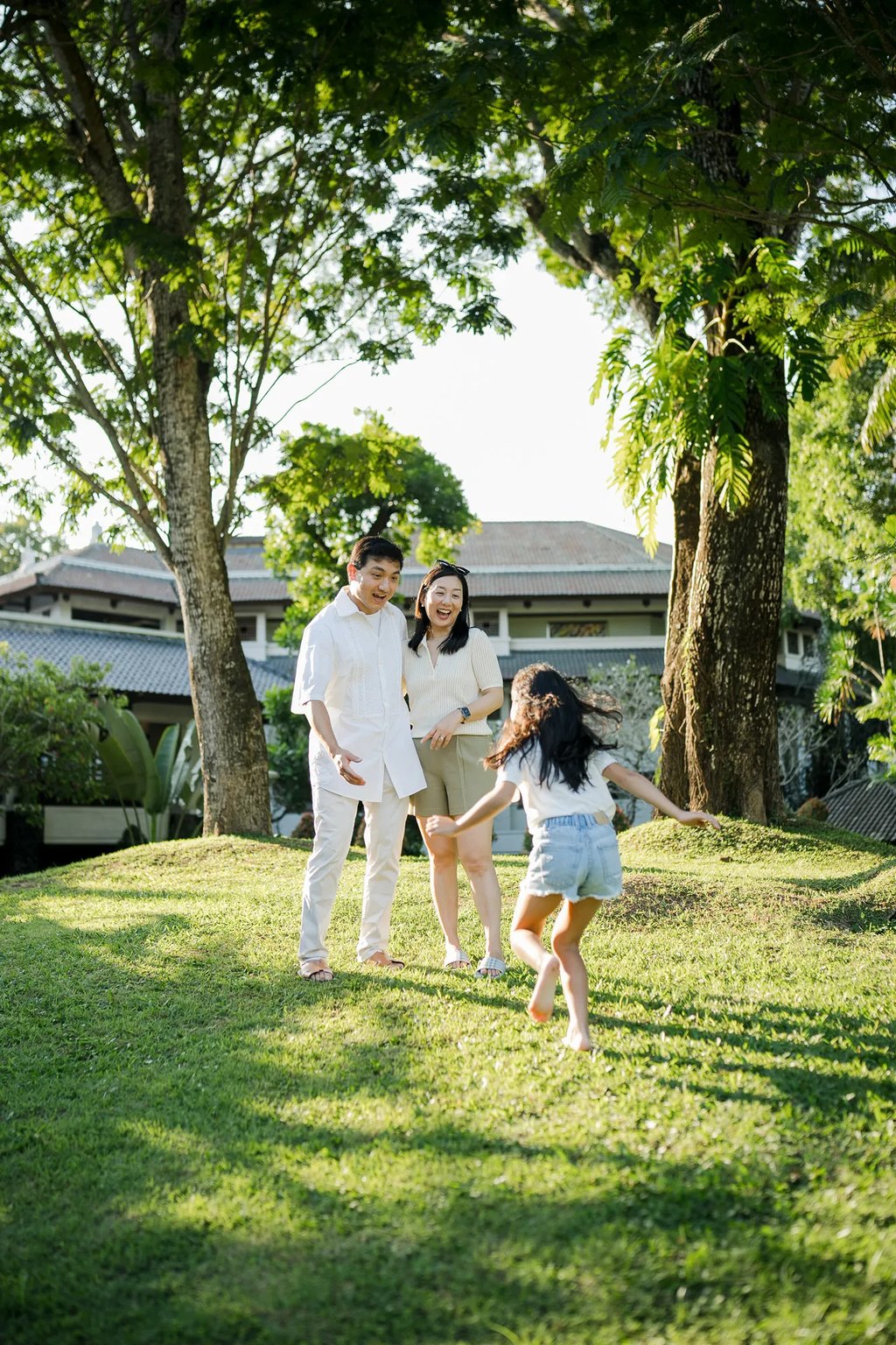 Family running together across the lawn at InterContinental Bali Resort Bali
