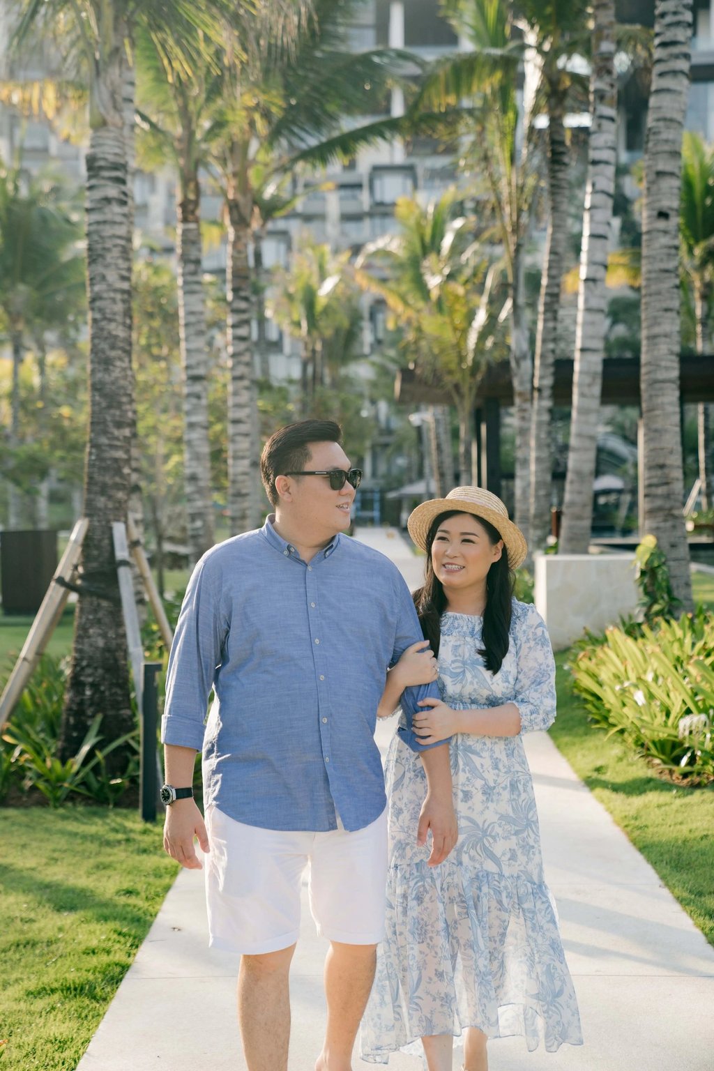 Mother and father walking together near the beach at The Apurva Kempinski Bali.